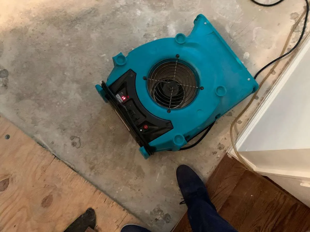 Air mover drying subfloor during Commercial Water Damage Restoration in Cloverleaf